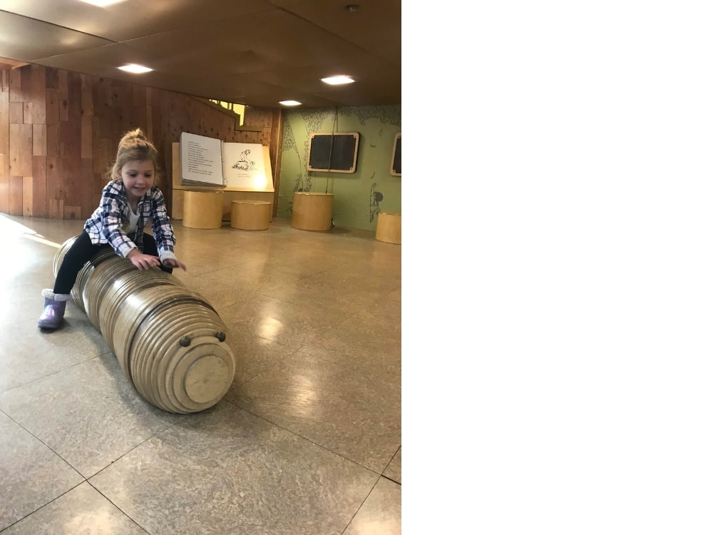 Playing on wooden lady bug