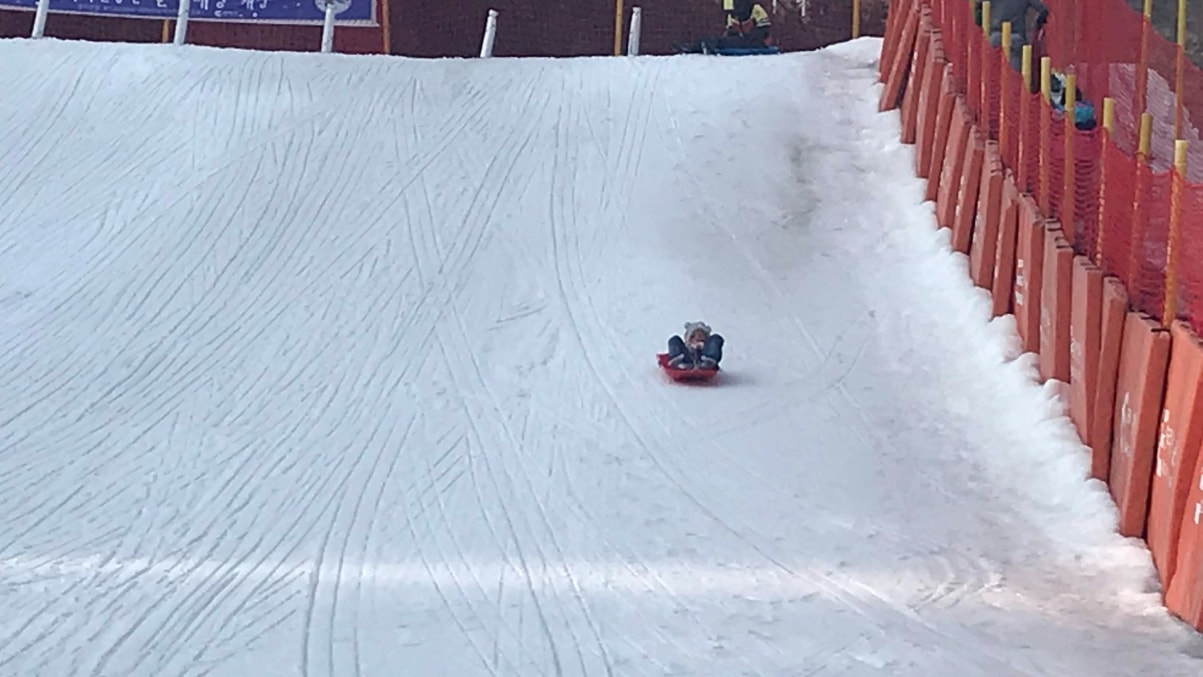 little girl on the sledding hill at Elysian ski resort